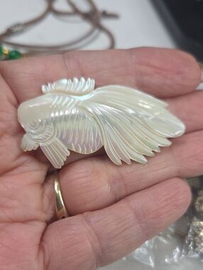 Carved mother of pearl fish brooch